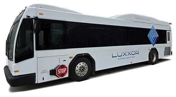 The exterior of a transit-style passenger bus with the Luxxor Campus Shuttles logo on it